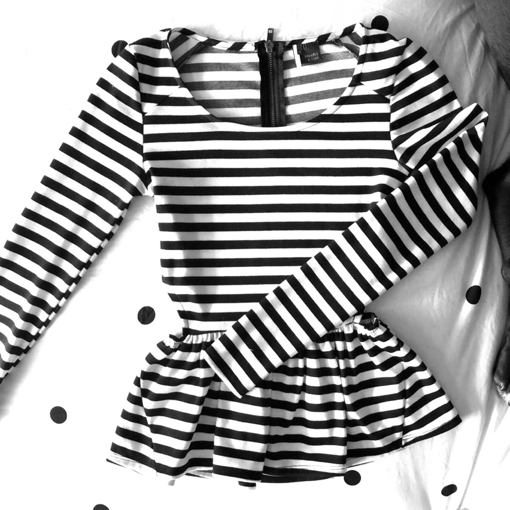 Adorable long sleeved peplum top with side cutouts